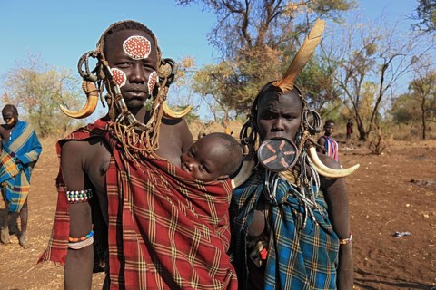 South Ethiopia, in Maco National Park, Mursi tribe, Mursi woman with baby, painted skin and