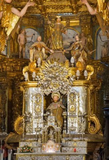 Detailed, baroque statue scene with figure of a saint on a richly decorated altar, cathedral,