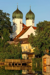 Romanesque Benedictine Abbey Seeon Monastery, monastery church St. Lambert with reflection in the