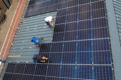 Installation of solar modules on the roof of a barn on a farm, over 210 photovoltaic modules are
