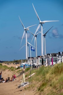 Wind turbines, wind farm, holiday homes, beach houses on the beach of Ijmuiden in North Holland,