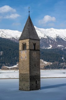 Church tower in Lake Reschen in winter, Reschen Pass, South Tyrol, Italy, Europe