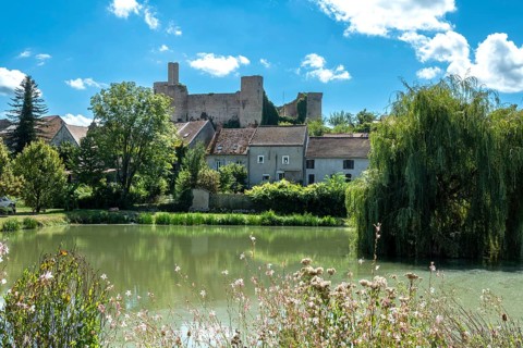 Billy. The fortified castle dating back to the 13th century, overlooks a pond, Allier,