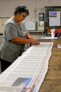 Liberal, Kansas, Lisa Diaz puts mailing labels on copies of the Kiowa County (Colorado) Independent