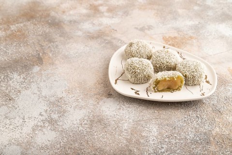 Japanese rice sweet buns mochi filled with pandan jam on brown concrete background. side view, copy