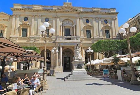 National Library building Queen Victoria statue and cafes in Republic Square, Valletta, Malta,