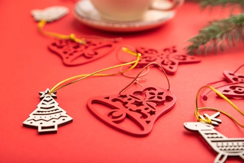 Christmas or New Year composition. Decorations, fir and spruce branches, cup of coffee, on a red