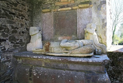 Weathered damaged memorials inside seventeenth century Kilcredan church ruins and graveyard, County