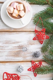 Christmas or New Year frame composition. Decorations, red stars, bells, cones, fir and spruce