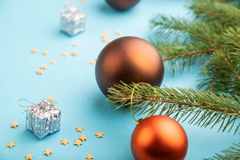 Christmas or New Year composition. Decorations, bronze balls, fir and spruce branches, on a blue