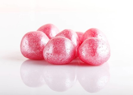 Heap of pink hard sugar candies isolated on white background