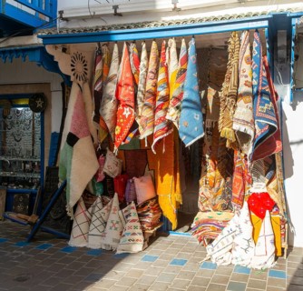Traditional rugs hanging on display outside shop in medina area of Essaouira, Morocco, north