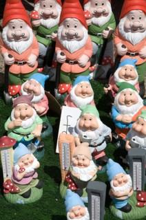 Colourful garden gnomes lined up for sale, UK