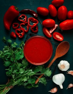 Tomato sauce, tomatoes and sweet pepper, Georgian Satsebeli sauce, with ingredients on a dark