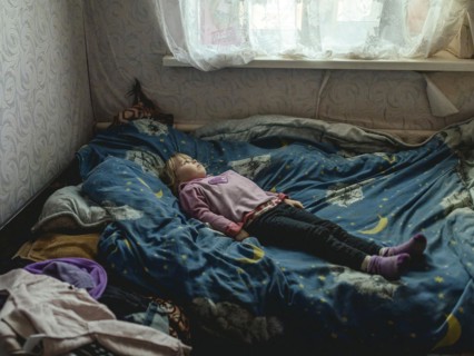 Angelina, 9 years old, on her bed. The village of Borshchivka was under Russian occupation. She has