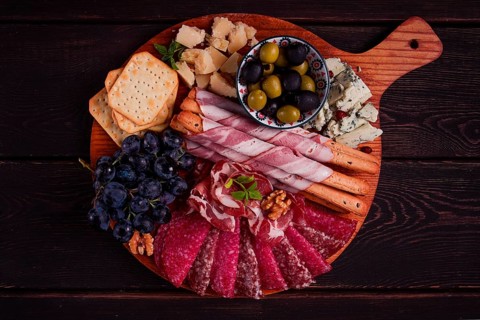 Appetizer, assortment, set, sausage, and cheese, on a wooden board, top view, no people