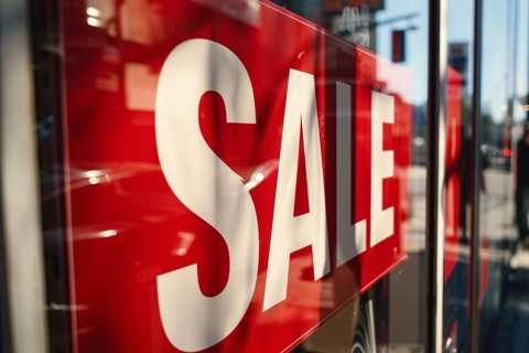 Red advertisement sign with text 'Sale' in shopping window. Generative AI, AI generated
