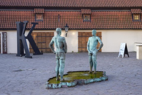 Two male figures peeing, sculpture by the artist David Cerny in front of the Franz Kafka Museum,