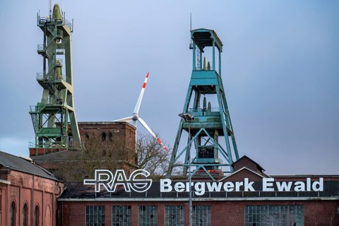 Former RAG Ewald mine, headframes, shaft 7, right and shaft 2, left, behind the wind power station