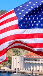 American star spangled flag waving in California. A large American flag is flying high above