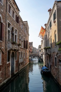 House facades with Venetian flag on a canal, Venice, Veneto, Italy, Europe