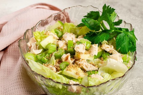 Waldorf salad, celery salad with apple, in a glass salad bowl, natural light, homemade, no people