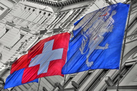 City Hall with Ticino Flag and Swiss Flags and Locarno Flag in City of Locarno, Ticino,