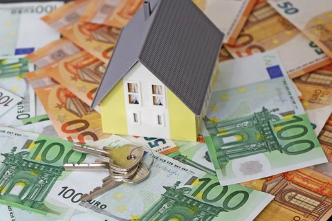 Concept photo with model house, euro notes and coins