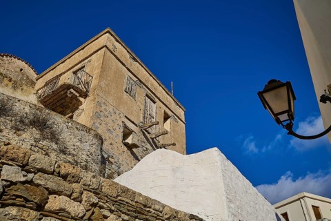 Stone walls and lamp in a Mediterranean village under a blue sky, Colourful mountain village,