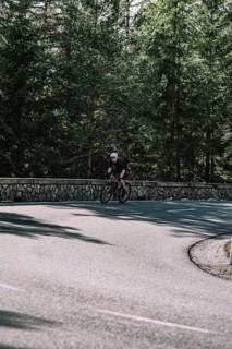 Road bike rider in spring in the Allgäu against the picturesque backdrop of the Alps, Bavaria,
