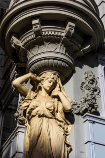 Female stone figure supporting a façade, Graben pedestrian zone, Vienna, Austria, Europe