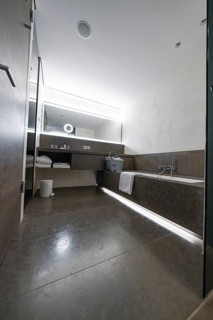 Modern bathroom with large shower, bathtub and illuminated mirror, Mayrhofen, Zillertal, Austria,