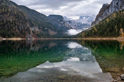 The Vordere Gosausee lake in autumn with a view of the Dachstein mountain range. The Gosaukamm on