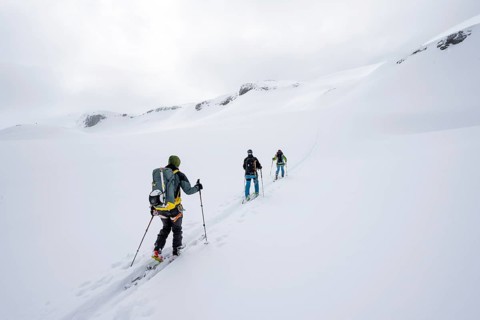 Ski tourer in the fog on the glacier Glacier de la Plaine Morte, mountain landscape with snow,