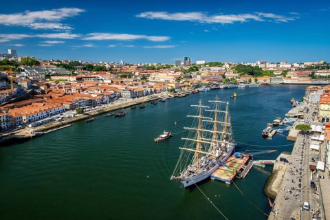 Aerial view of Porto city and Vila Nova de Gaia and Douro river with moored sailling ship from Dom