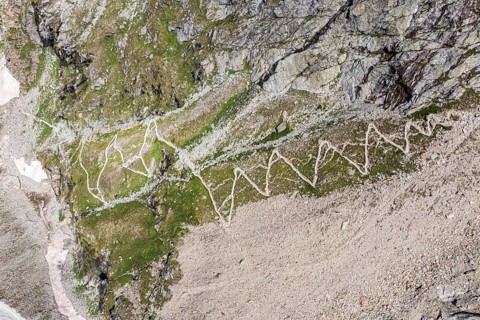 Serpentines of hiking trail up to mountain hut Cabane de Moiry, aerial view, Valais, Switzerland,