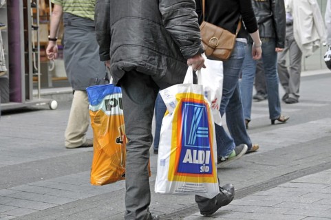 Old man after shopping at the discounters: plus and Aldi-Süd, pedestrian zone in Cologne, North