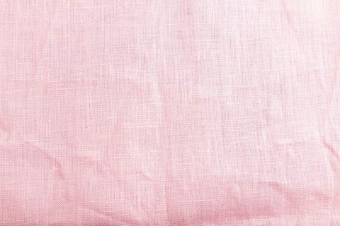 Fragment of smooth pink linen tissue. Top view, flat lay, natural textile background and texture