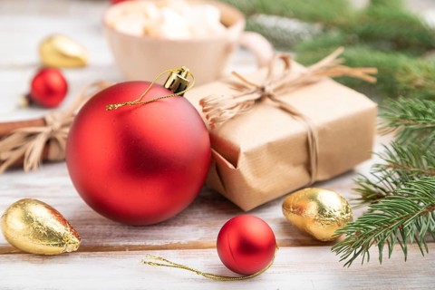 Christmas or New Year composition. Decorations, box, red balls, cinnamon, fir and spruce branches,