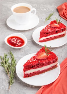 Homemade red velvet cake with milk cream and strawberry with cup of coffee on a gray concrete
