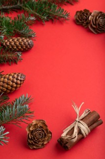 Christmas or New Year composition. Decorations, box, cinnamon, cones, fir and spruce branches, cup