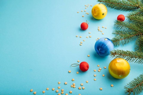Christmas or New Year composition. Decorations, blue, red, yellow balls, fir and spruce branches,