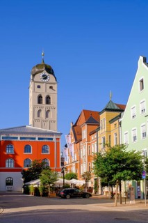 Facade of the savings bank, tower of St Johannes, Erdinger-Weißbräu on Schrannenplatz, Erding,