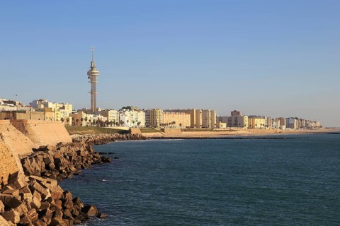 Coastal view east of rock armour coastal defences near city centre, Cadiz, Spain, Europe