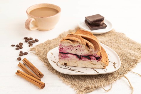 Zephyr or marshmallow cake with cup of coffee on white wooden background and linen textile. side