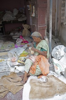 Indian woman making pappadam or Indian bread on the footpath, Kochi, Kerala, India, Asia