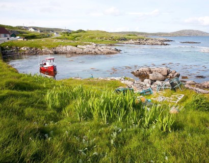 Small fishing boat at moorings on the east coast of Barra, Outer Hebrides, Scotland, UK