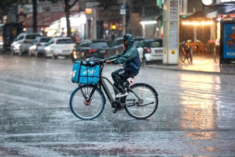 A Volt delivery driver drives along Potsdamer Strasse in the pouring rain. After weeks of heat, the