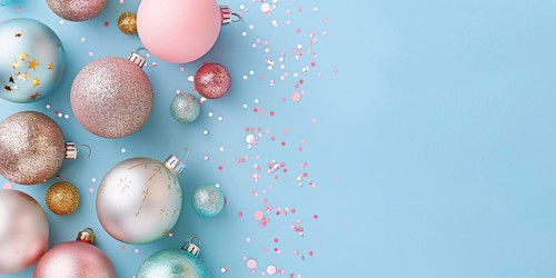 Christmas flatlay with blue and pink colored tree baubles on pastel background with copy space.