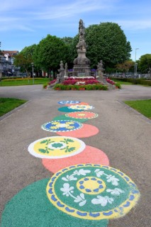 18th century statue of Viana with flower motives on the ground during the Flower festival, Viana do